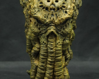 May include: A detailed, sculpted bust of a Cthulhu-like creature with tentacles, a textured, green and brown color scheme, and a menacing expression.