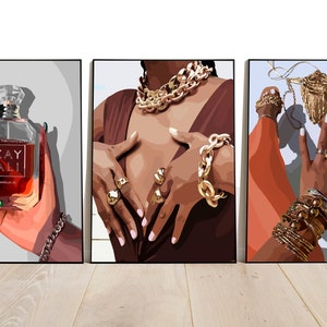 May include: Triptych of art prints featuring illustrations of fashion and beauty. One print shows a perfume bottle with the text "KAY ALI". The other two prints depict hands adorned with gold jewelry, including rings, bracelets, and necklaces.
