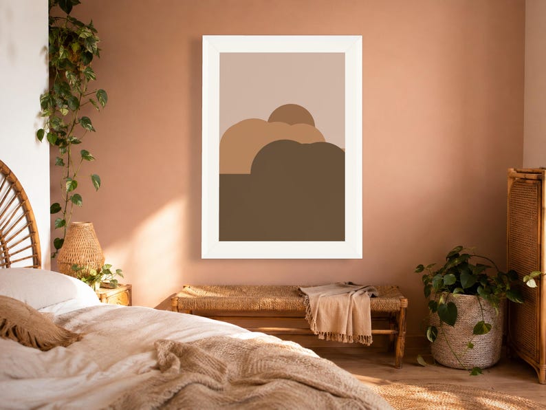 Puede incluir: Una impresi&oacute;n de arte mural enmarcada que presenta una composici&oacute;n de paisaje abstracto minimalista. La obra muestra formas redondeadas superpuestas en varios tonos de marr&oacute;n, bronceado y beige, sobre un fondo gris pardo en un marco blanco.
