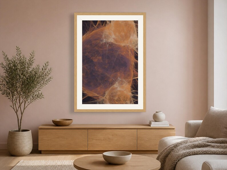 May include: A rectangular wall art print featuring an abstract composition of wispy, translucent orange and amber fibers set against a deep, dark background, enclosed within a simple light-toned wooden frame with a wide white mat border.
