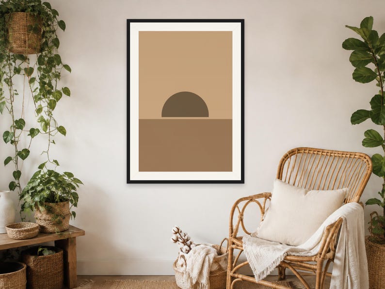 May include: A framed wall art print featuring a geometric composition with a dark brown semi-circle positioned above a solid brown horizontal band against a light tan background, enclosed within a thin black frame hanging on a plain wall.