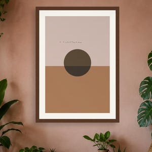 May include: A framed wall art print featuring a split-tone background with a light beige upper half and a terracotta lower half. A large, dark brown circle is centered over the horizon line, and a small flock of birds is visible in the upper section.