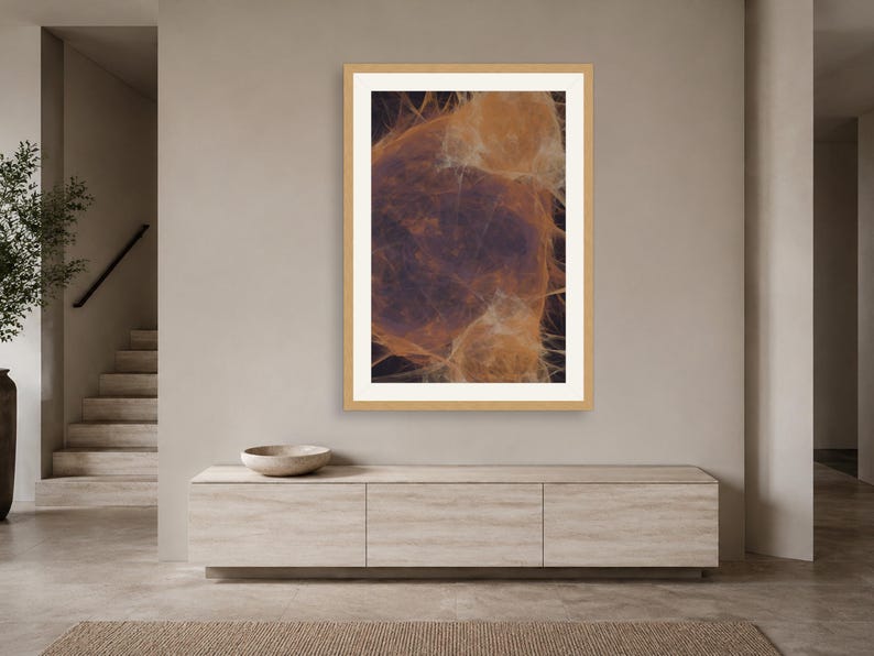 May include: A framed vertical wall art print featuring an abstract composition of wispy, glowing orange and amber filaments set against a deep, dark charcoal background, enclosed within a light-toned wooden frame and a wide white mat border.