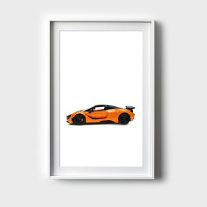 May include: A framed print of an orange sports car with a black interior and black wheels. The car is on a white background.