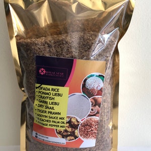 May include: A gold resealable bag filled with brown rice. The bag has a label with the text "Royal Star Marketplace" and a list of ingredients including "Ofada Rice", "Ponmo Ijebu", "Crayfish", "Garri Ijebu", "Dry Snail", "Tiger Prawn", "Agoyin Sauce Mix", "Bleached Palm Oil", and "Ayamasse Pepper Mix".