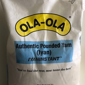 May include: A white bag with a yellow and black logo that says "OLA-OLA" and the text "Authentic Pounded Yam (lyan) IYANINSTANT™"  "You've had the rest, now taste the best."  The bag also has the text "Manufactured by: Yusol International Foods Sacramento, CA 95828 www.yusolfood.com" and "NET WT. 18.5 lb. (8.4kg)"