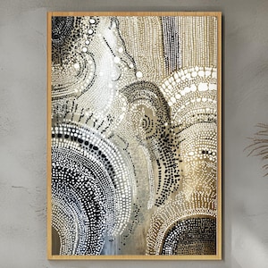 May include: Abstract art print in a wooden frame. The artwork features a pattern of black, white, and tan dots arranged in swirling, circular shapes. The design has a textured appearance, creating a sense of depth and movement. The colour palette is neutral, with a focus on contrast.