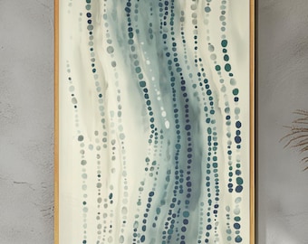 May include: Abstract art print in a wooden frame. The artwork features a flowing design of blue and teal dots and lines against a cream background. The dots vary in size and density, creating a sense of movement and depth. The frame is a light brown color.