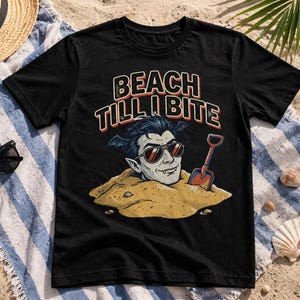 May include: Black t-shirt with the text "BEACH TILL I BITE" above a cartoon vampire wearing sunglasses and buried in sand, holding a small shovel. The design has red, orange, and blue accents.