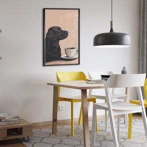 May include: A black and white illustration of a dog sitting at a table with a cup of coffee. The dog is looking to the right. The illustration is framed and hanging on a wall in a dining room.