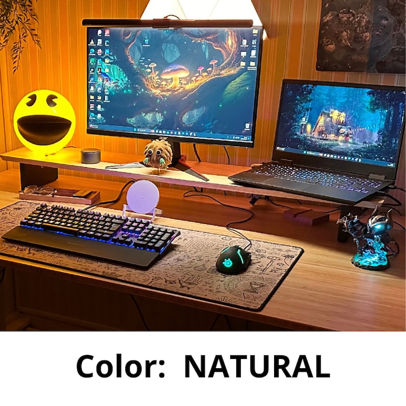 May include: A wooden desk with a computer monitor, keyboard, mouse, and a small figurine. The desk is decorated with a yellow smiley face lamp and a small plant. The desk is lit by a lamp and the room is decorated with a wooden wall.