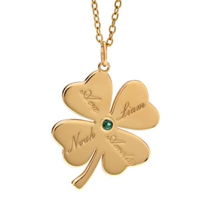 May include: Gold four-leaf clover necklace with a green gemstone in the center and four names engraved on the leaves: Noah, Amelia, Liam, and Ava.
