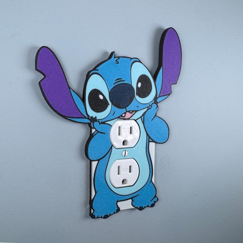 May include: A blue and purple Stitch character wall plate cover with two standard US electrical outlets.