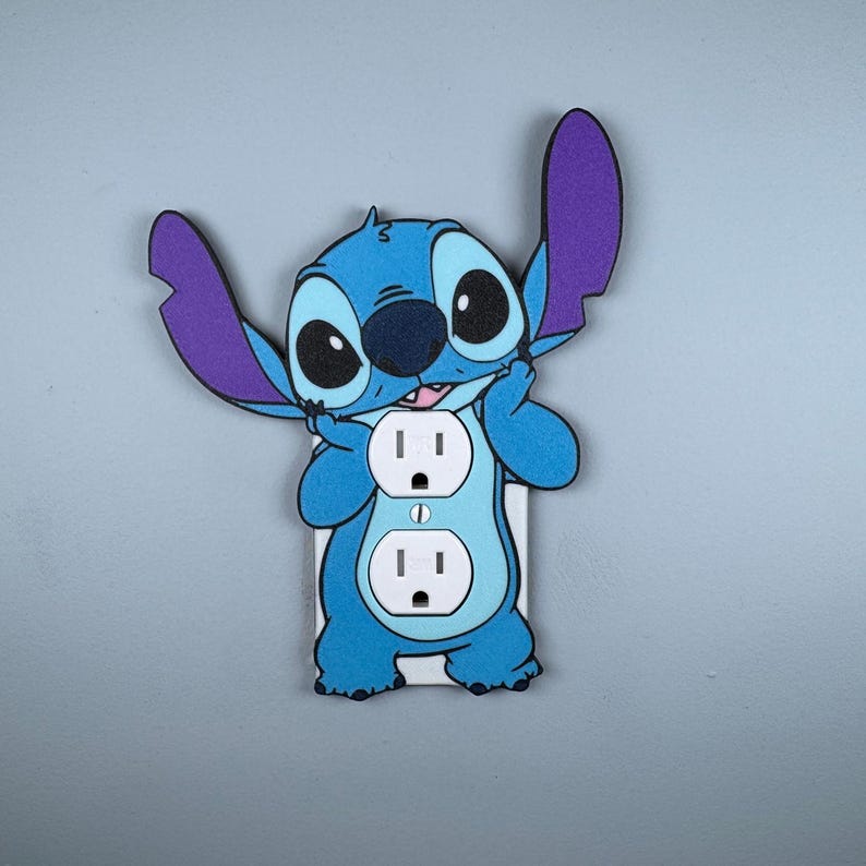 May include: A blue and purple Stitch character light switch cover with two standard US electrical outlets.