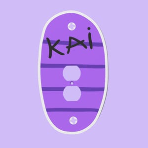 May include: A purple and white light switch cover with the name "KAI" in black handwritten letters. The cover has two outlet holes and is decorated with horizontal purple stripes and white accents.