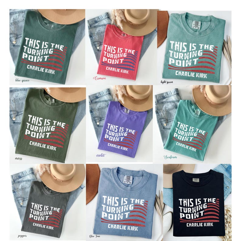 May include: Nine different colored t-shirts are displayed, each with the text "THIS IS THE TURNING POINT CHARLIE KIRK" in white. The shirts are paired with jeans and a hat. Colors include blue spruce, crimson, light green, moss, violet, seafoam, pepper, blue jean, and black.
