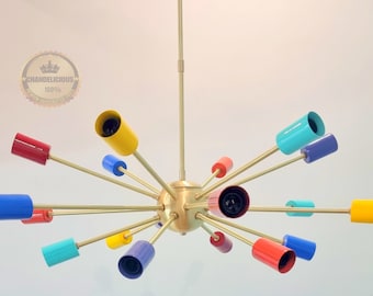 May include: A brass chandelier with 16 colourful glass shades. The shades are in various colours, including red, yellow, blue, and green. The chandelier has a starburst design with the arms extending out from a central sphere.