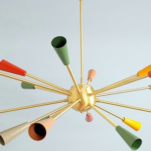 May include: A gold-toned, multi-light chandelier with a starburst design. The chandelier has 15 lights with colorful shades in shades of green, orange, red, and pink.