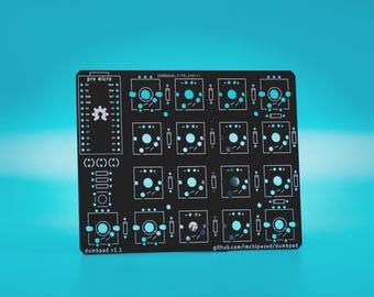May include: A black printed circuit board for a mechanical keyboard macro pad featuring a four-by-four grid of switch sockets. The board includes labels for a pro micro controller, the text dumbpad v1.1, and github.com/imchipwood/dumbpad.