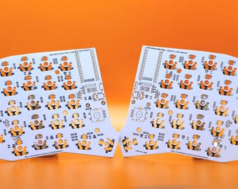 May include: Two white printed circuit boards for a split keyboard, featuring a symmetrical layout with numerous circular orange switch sockets, various electronic component footprints, and small text labels printed across the surface.