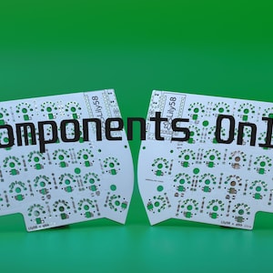 May include: Two white Lily58 printed circuit boards for a split mechanical keyboard, featuring green solder pads and various electronic component footprints. The text "Components Only" is overlaid in black across the center of both boards.