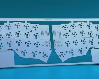 May include: A white printed circuit board for a split mechanical keyboard, featuring a symmetrical layout with numerous circular switch cutouts and mounting holes. The board includes the text "Corne" and "Corne Cherry V3.0 PCB designed by foostan".