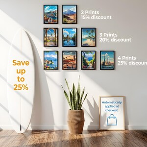 May include: A collection of nine framed travel art prints displayed on a wall, featuring various global landscapes. A white surfboard stands to the left with text reading Save up to 25%. Text on the right details discounts for multiple prints.