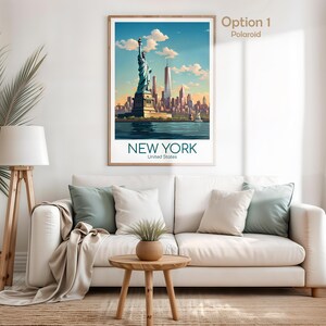 May include: A framed wall art print featuring a stylized illustration of the Statue of Liberty and the New York City skyline. The text "NEW YORK" and "United States" is printed at the bottom. The artwork displays blue, orange, and tan tones.