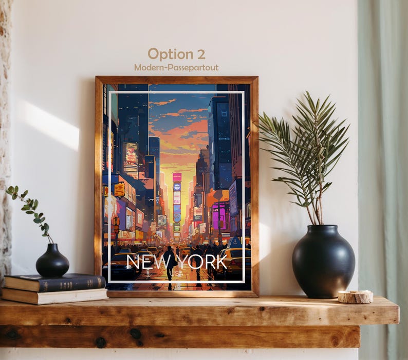 May include: A framed vertical art print featuring a stylized illustration of a New York City street scene at sunset with tall buildings, glowing billboards, and yellow taxis. The text NEW YORK USA is printed in white at the bottom of the image.