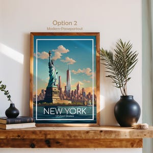 May include: A framed art print featuring a stylized illustration of the Statue of Liberty and the New York City skyline under a blue sky with clouds. The text NEW YORK United States is printed at the bottom. The frame is brown wood.