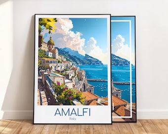 May include: Two framed art prints featuring a coastal scene of Amalfi, Italy. The artwork depicts buildings, mountains, and the sea under a blue sky. The word "AMALFI" is printed in blue, with "Italy" below it.