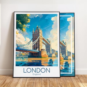May include: Two framed art prints featuring a stylized illustration of the Tower Bridge in London. The artwork depicts the bridge over water under a blue sky with clouds. The word "LONDON" and "England" are printed at the bottom of the primary print.