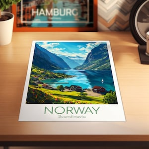 May include: A colorful illustration of a fjord in Norway. The image shows a narrow, winding waterway surrounded by steep, green mountains. There are small houses and boats on the water. The text "NORWAY" and "Scandinavia" is at the bottom of the image.