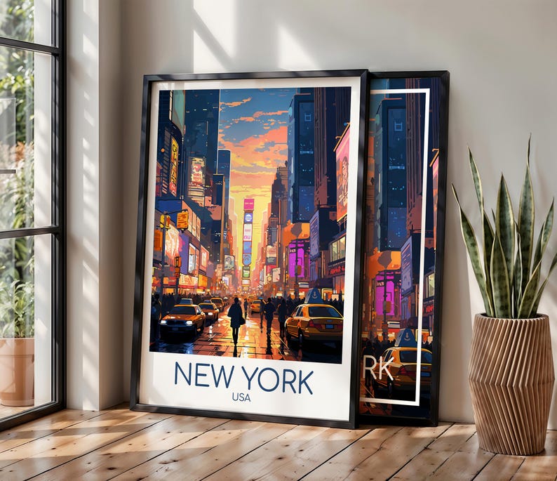 May include: A framed art print featuring a vibrant illustration of a New York City street scene at sunset, with yellow taxis, tall buildings, and glowing billboards. The text NEW YORK USA is printed in bold blue letters at the bottom of the white border.