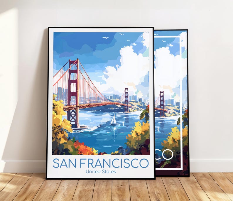 May include: Two framed art prints featuring the Golden Gate Bridge in San Francisco. The artwork depicts the bridge in a colorful, stylized illustration with a blue sky, water, and a sailboat. The text "SAN FRANCISCO United States" is at the bottom.