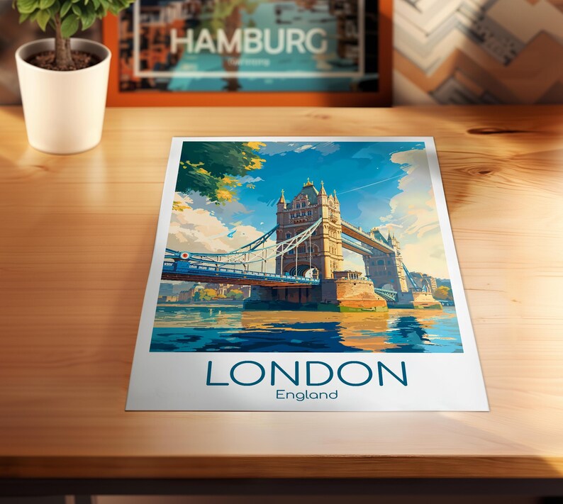 May include: A colorful print of the Tower Bridge in London, England, with the word "LONDON" and "England" printed at the bottom. The artwork depicts the bridge over water under a blue sky with clouds.