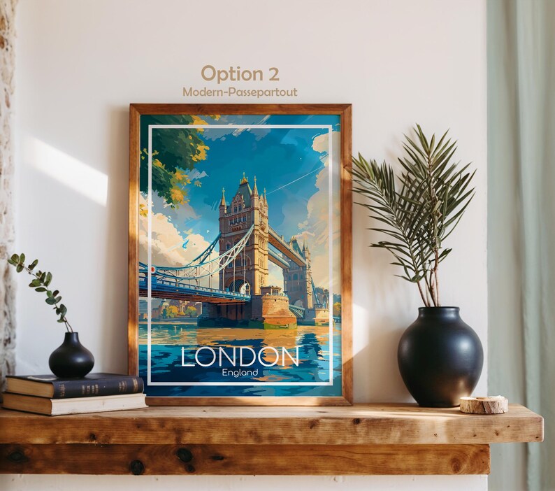 May include: A framed art print featuring the Tower Bridge in London, England. The artwork has a vintage travel poster style with a blue, white, and gold color scheme. The word "LONDON" is displayed prominently at the bottom of the image.