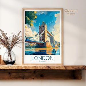 May include: A framed art print featuring the Tower Bridge in London, England. The artwork depicts the bridge over the water with a blue sky and clouds. The word "LONDON" is printed in large letters at the bottom.