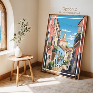 May include: A rectangular framed wall art print featuring a colorful illustration of a Lisbon street scene with pastel buildings, balconies, and a church tower under a blue sky. The print includes the white text LISBON Portugal at the bottom.