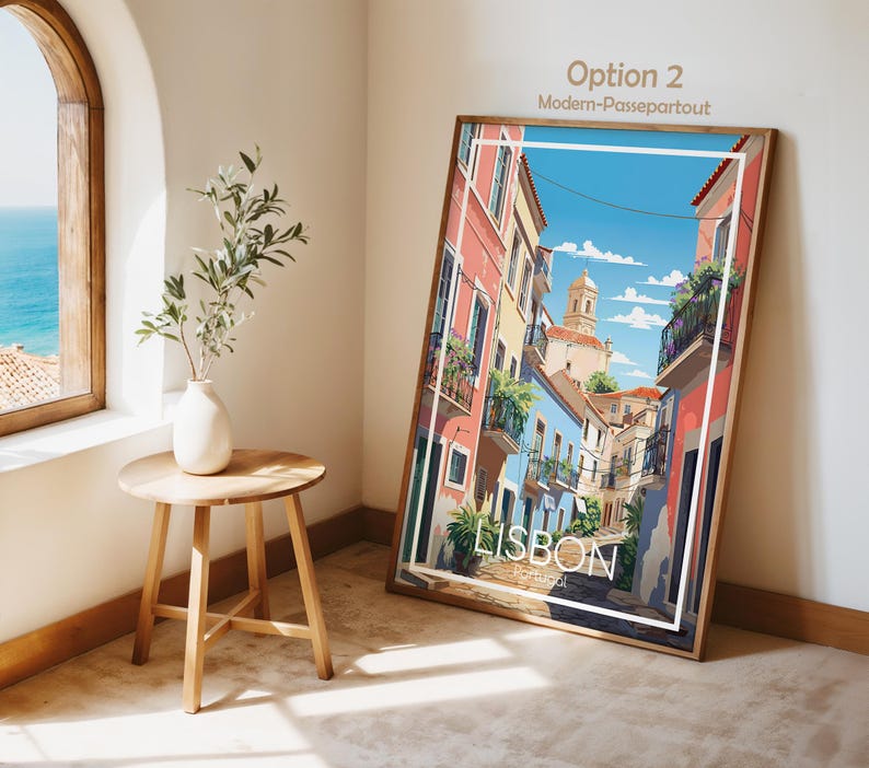 May include: A rectangular framed wall art print featuring a colorful illustration of a Lisbon street scene with pastel buildings, balconies, and a church tower under a blue sky. The print includes the white text LISBON Portugal at the bottom.