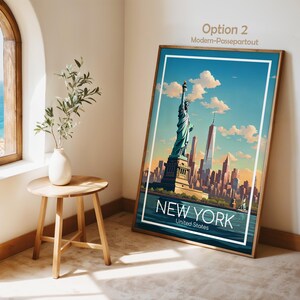 May include: A framed vertical art print featuring a stylized illustration of the Statue of Liberty and the New York City skyline under a blue sky with clouds. The text NEW YORK United States is printed in white at the bottom of the artwork.