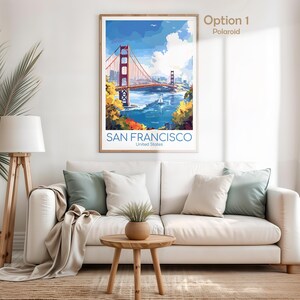May include: A framed art print of the Golden Gate Bridge in San Francisco. The artwork features the bridge in red, with blue water and sky. The text "SAN FRANCISCO United States" is at the bottom.