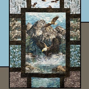 May include: A quilted wall hanging featuring a mountain scene with eagles in flight. The word "Fondue" is at the top. The design includes a central image of eagles over water, surrounded by forest and mountain imagery.