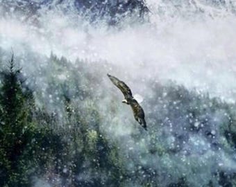 May include: A bald eagle with brown and white plumage soars through a snowy atmosphere above a dense forest of dark green pine trees, set against a backdrop of towering, jagged, snow-capped mountain peaks under a cloudy, overcast sky.