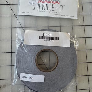 May include: A roll of grey chenille trim, labelled "BB56 GREY" and "CHENILLE-IT blooming bias". The label also states "Approx. 25 yards 100% Cotton" and "Made in the USA".