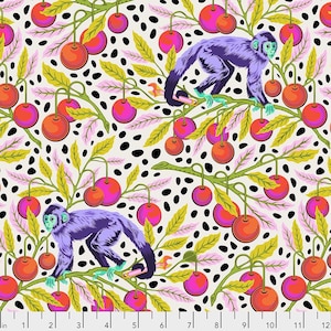 May include: A fabric pattern featuring purple monkeys perched on green branches with orange and pink cherries against a cream background with black spots. A white ruler with black markings is visible at the bottom, measuring up to 12 inches.