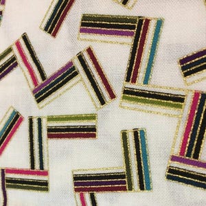 May include: Close-up of white fabric with scattered rectangular designs. Each rectangle features vertical stripes in various colors, including pink, teal, purple, and green, outlined with gold metallic thread. The overall pattern is abstract and decorative.