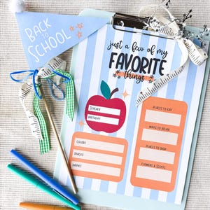 May include: A clipboard with a blue and white striped background, featuring the text "just a few of my FAVORITE things." A light blue pennant reads "BACK TO SCHOOL." Includes a red apple graphic and colorful pens.