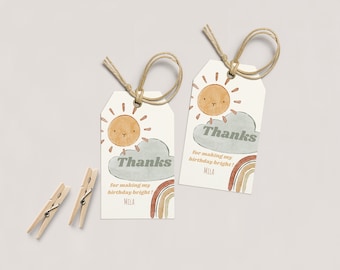 May include: Two watercolor-style thank you tags with a sun, clouds, and rainbow design. The text reads "Thanks for making my birthday bright!" with the name "Mila" at the bottom.