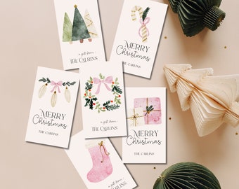 May include: Set of six pink and green Christmas gift tags with watercolor illustrations of a Christmas tree, candy cane, wreath, stocking, ornaments, and a gift box. Each tag has the text "a gift from: THE CARLINS" and "MERRY CHRISTMAS".